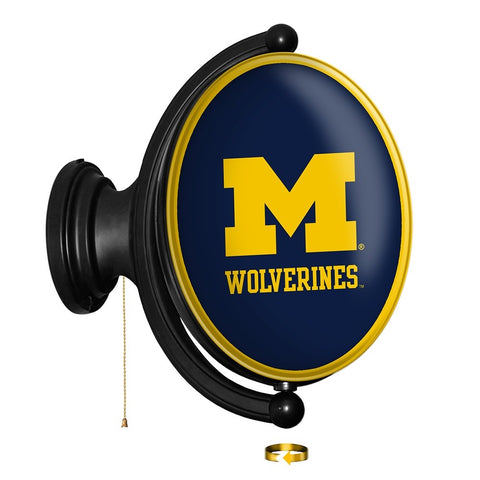 Michigan Wolverines: Maize - Original Oval Rotating Lighted Wall Sign - The Fan-Brand
