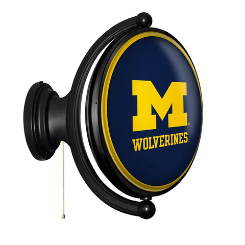 Michigan Wolverines: Maize - Original Oval Rotating Lighted Wall Sign - The Fan-Brand