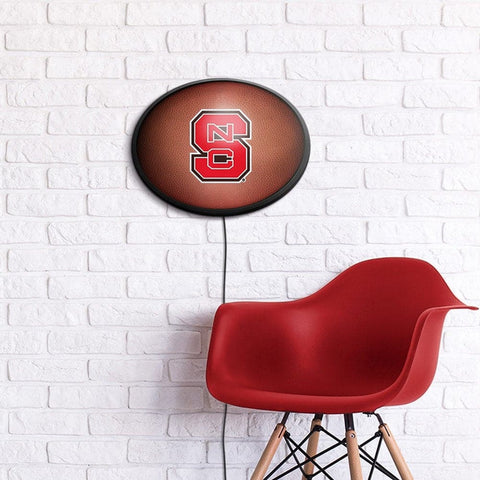 NC State Wolfpack: Pigskin - Oval Slimline Lighted Wall Sign - The Fan-Brand