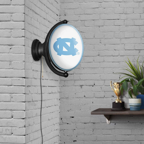 North Carolina Tar Heels: Original Oval Rotating Lighted Wall Sign - The Fan-Brand