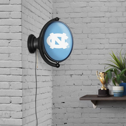 North Carolina Tar Heels: Original Oval Rotating Lighted Wall Sign - The Fan-Brand